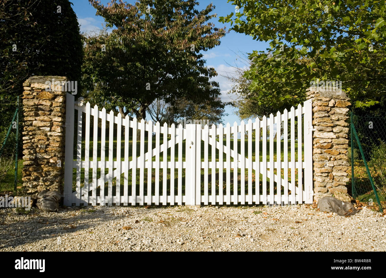 Closed white wooden gates to a french garden, St Simeon Village, Ile de France, Northern France Stock Photo
