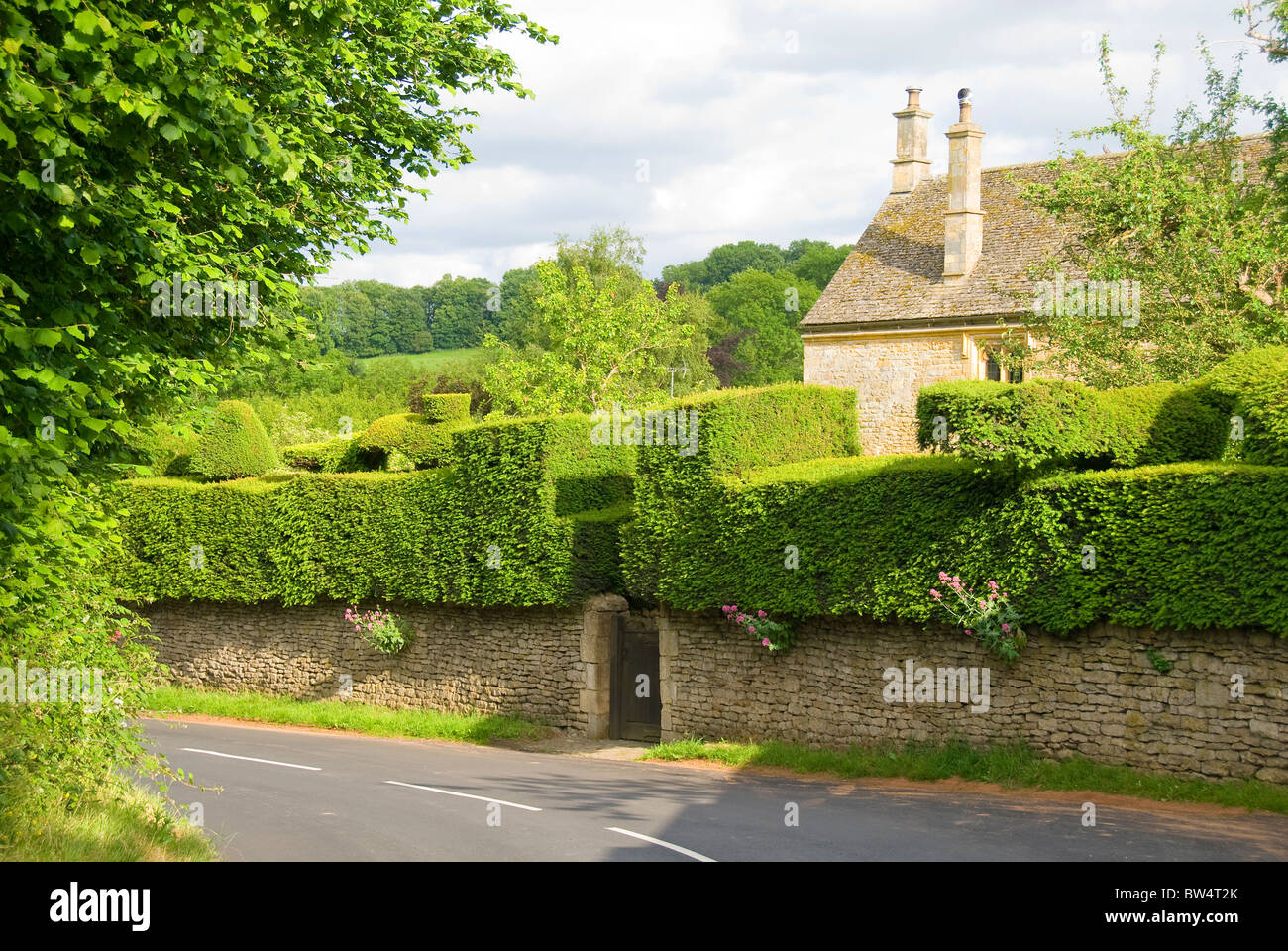 Home with a garden hedge on a wall, Broad Campden, Cotswolds, Cotswold