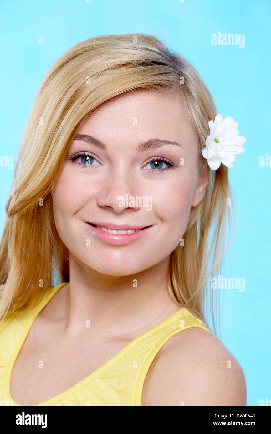 Portrait of pretty girl looking at camera over blue background Stock ...