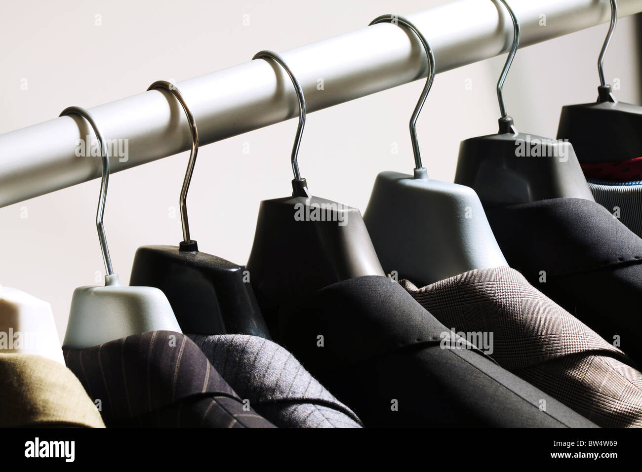 Photo of hangers with jackets on them in boutique Stock Photo