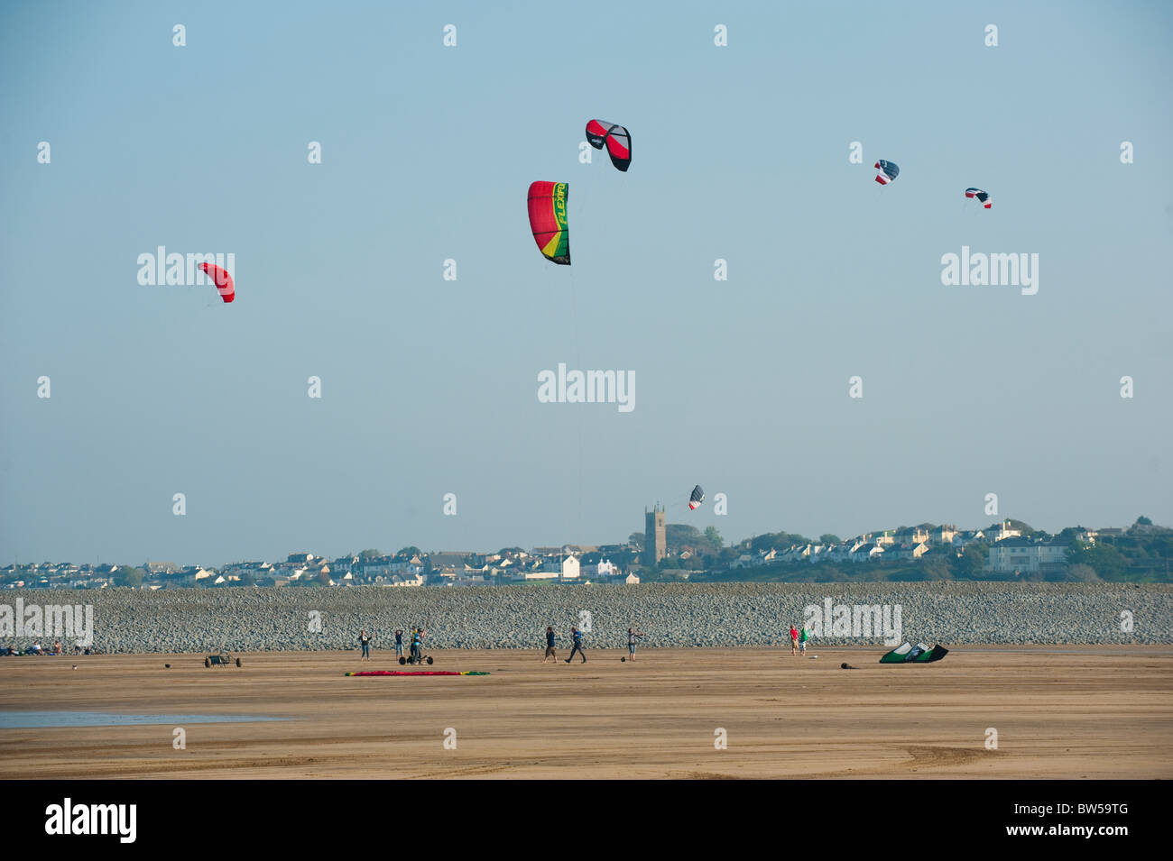 Kite flying on the beach at Westward Ho! with Northam church, Devon UK Stock Photo