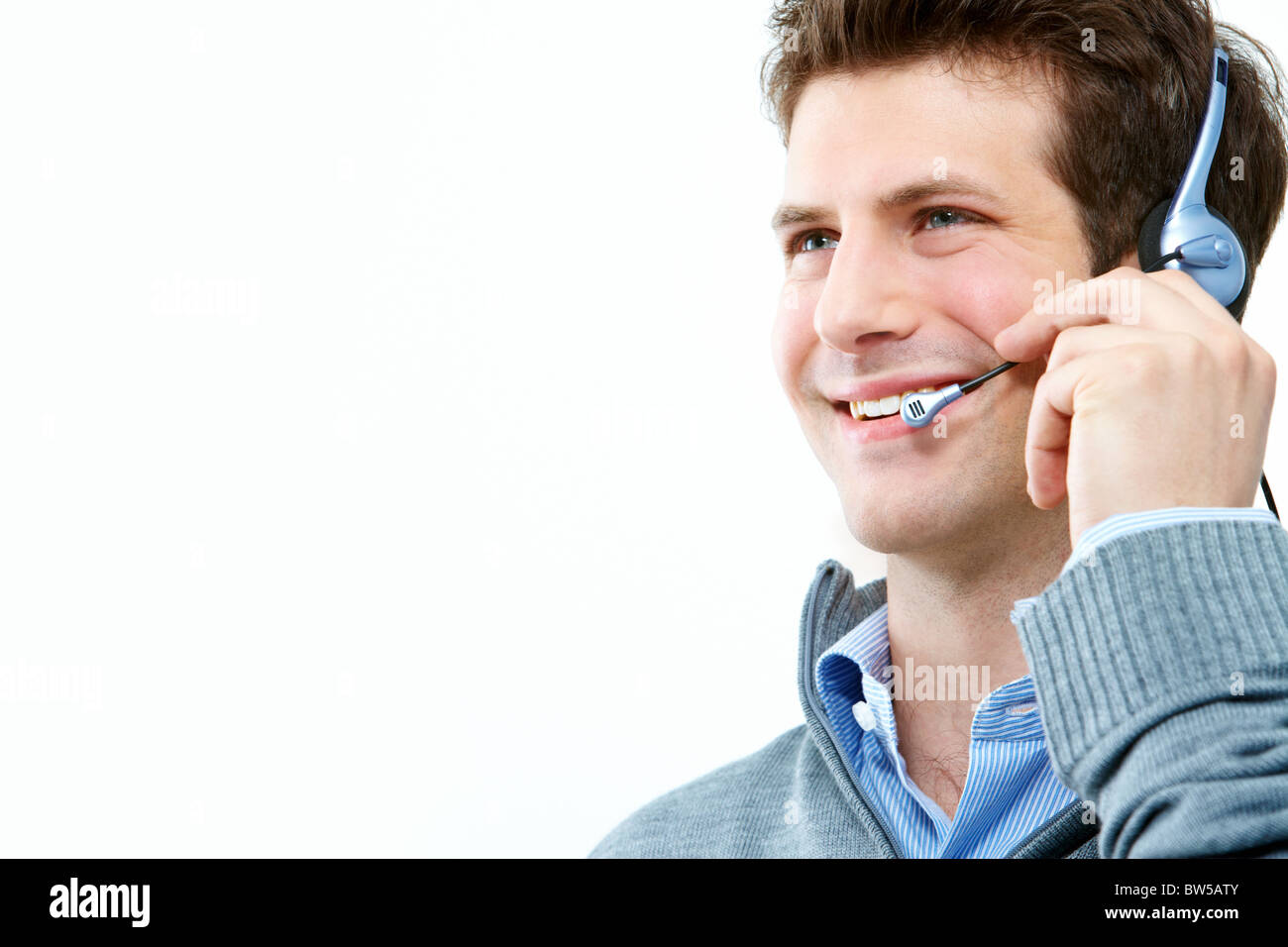 Photo of handsome guy speaking on the headset over white background ...