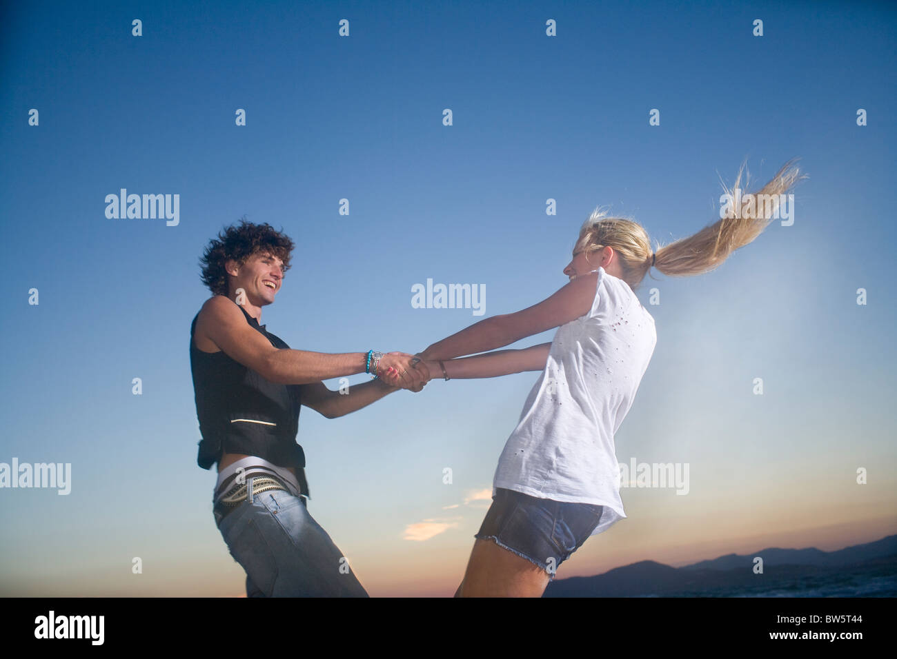 Young cple twirl outside fun Stock Photo