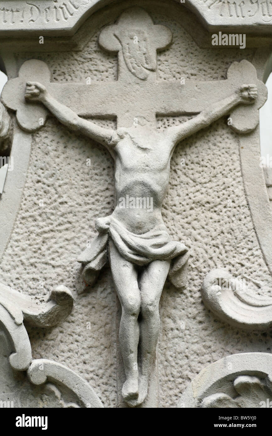 Destroyed tombstone. Sculpture of Christ without head. Stock Photo