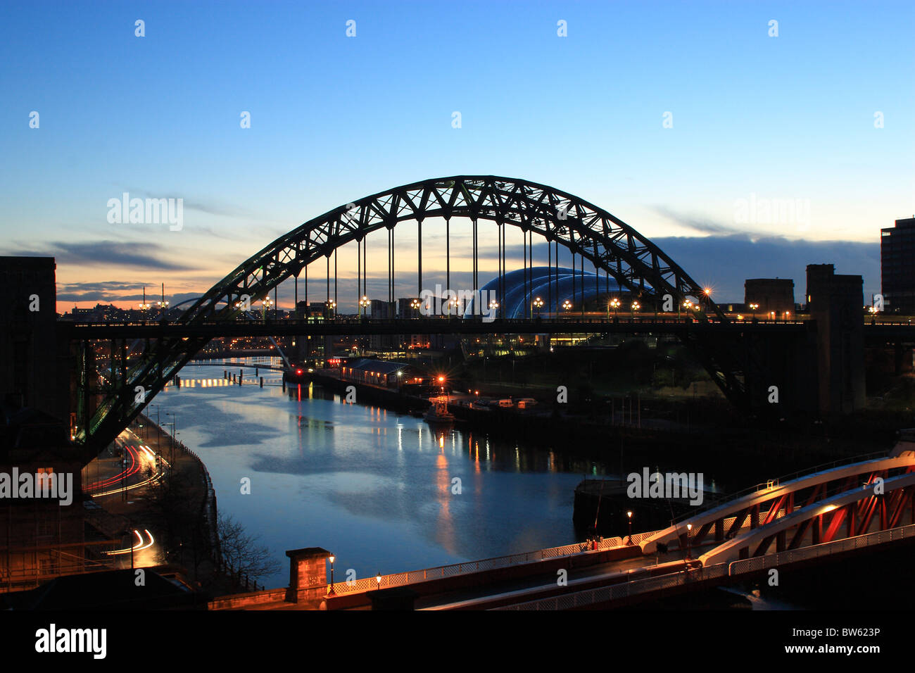 A view of the River Tyne at sunrise showing the Tyne Bridge and Sage Centre. Newcastle, Tyne and Wear. Stock Photo