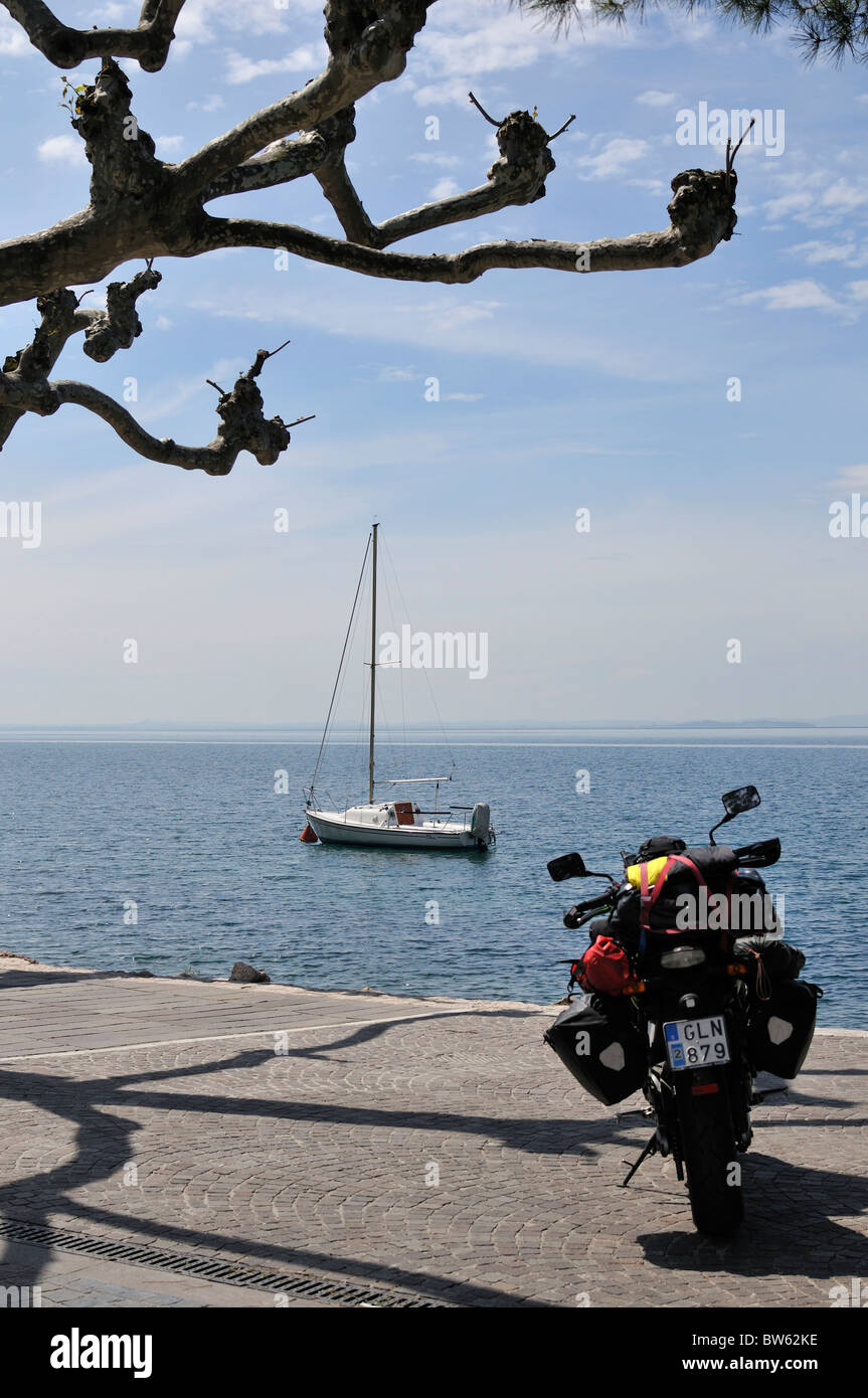 Motorcycle and sailing boat at Lake Garda, Garda, Verona, Italy Stock Photo