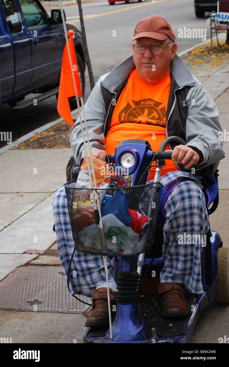Man uses his motorized chair to get about Stock Photo Alamy