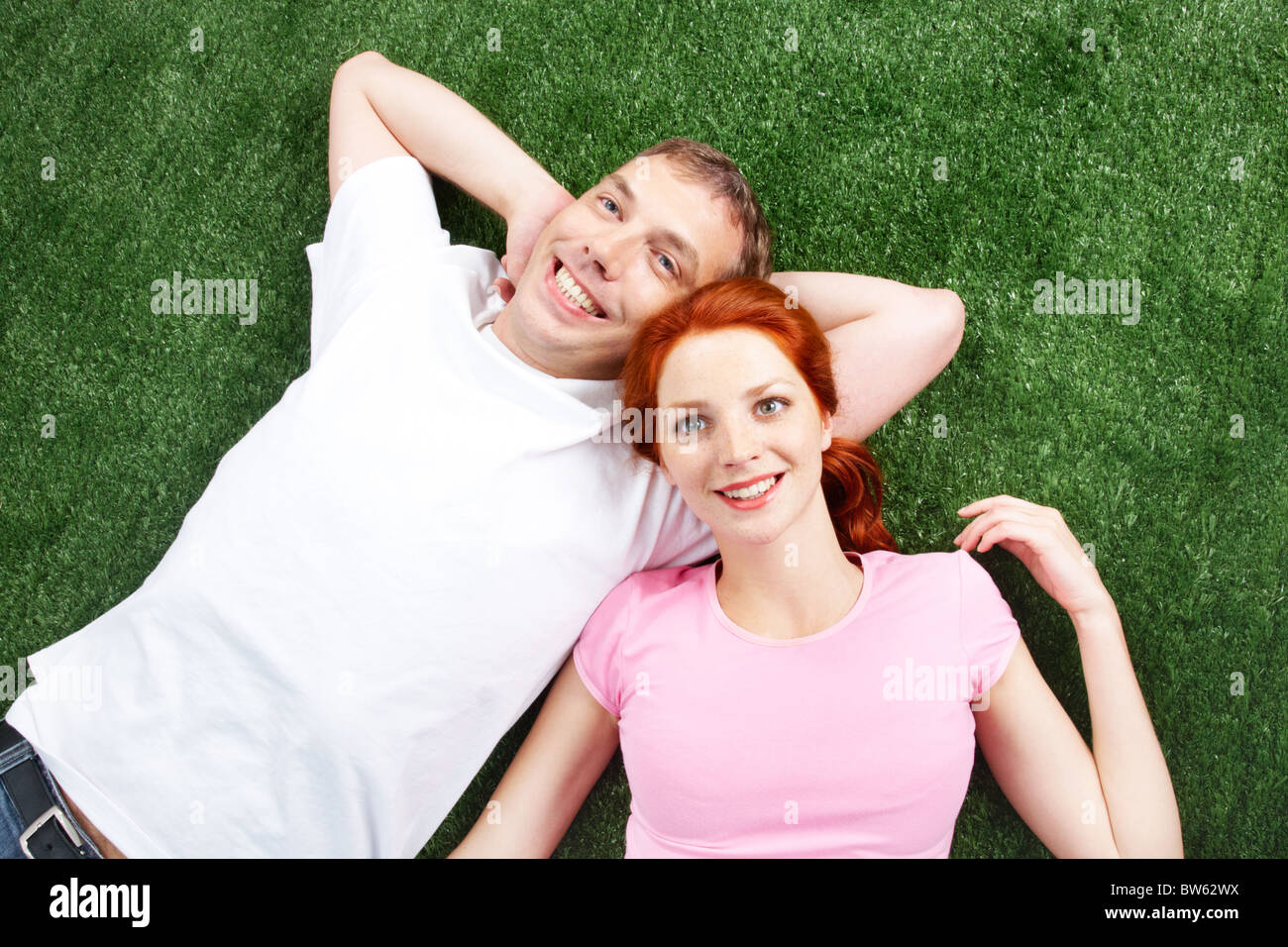 Image of young happy couple lying on grass and looking at the sky Stock ...