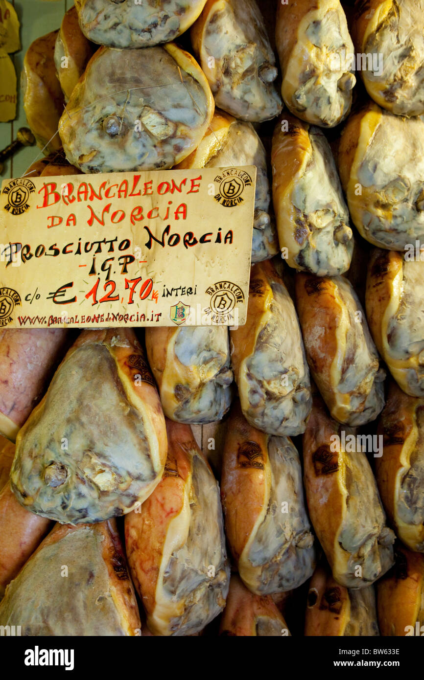 Fresh ham (Prosciutto) for sale at meat and cheese shop in Norcia, Umbria Italy Stock Photo