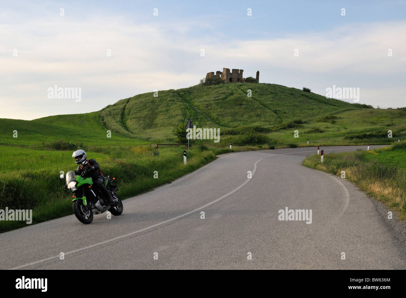 Motorcyclist in front of San Gimignano, Tuscany, Italy Stock Photo