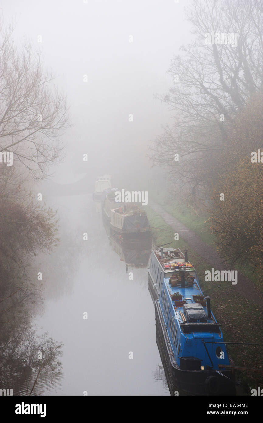 Narrowboats on the Oxford Canal on a misty day near Wolvercote. Stock Photo