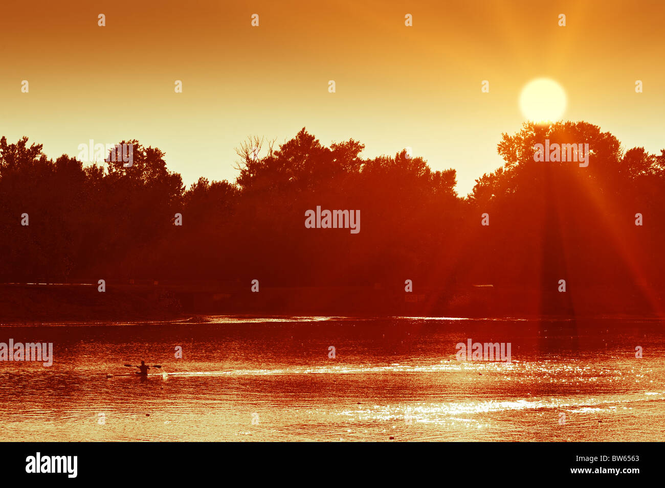 Canoeing man silhouette on sunset lake. Jarun lake, Zagreb, Croatia Stock Photo