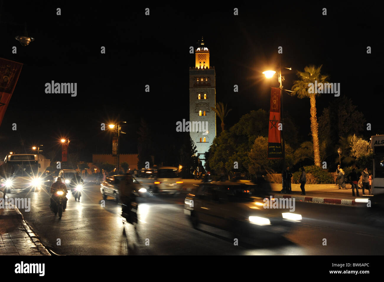 Traffic rushes past the famous Koutoubia Mosque in Marrakesh Morocco at night Stock Photo