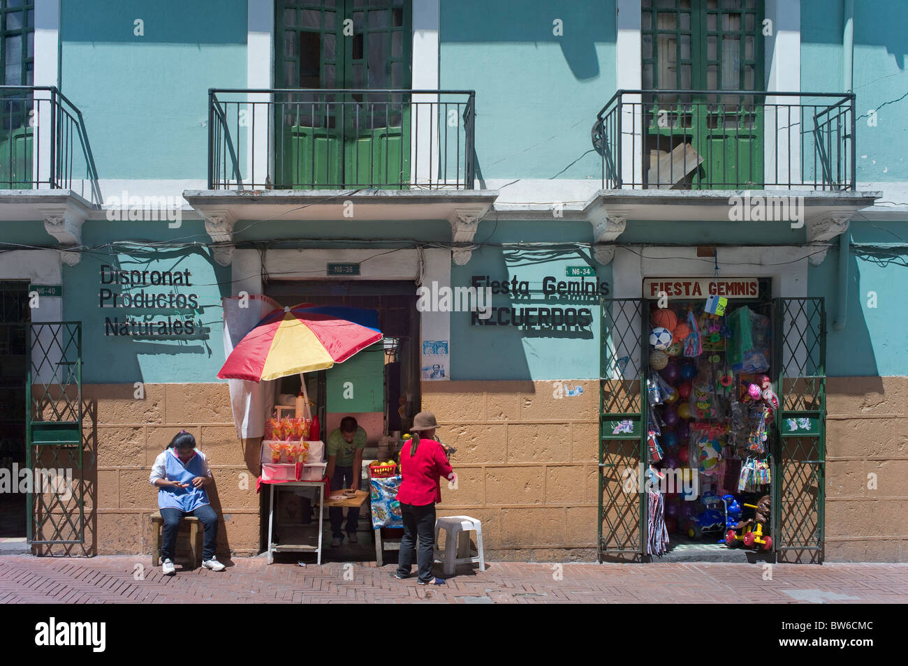 Building with shops, women selling things, Quito, Ecuador Stock Photo