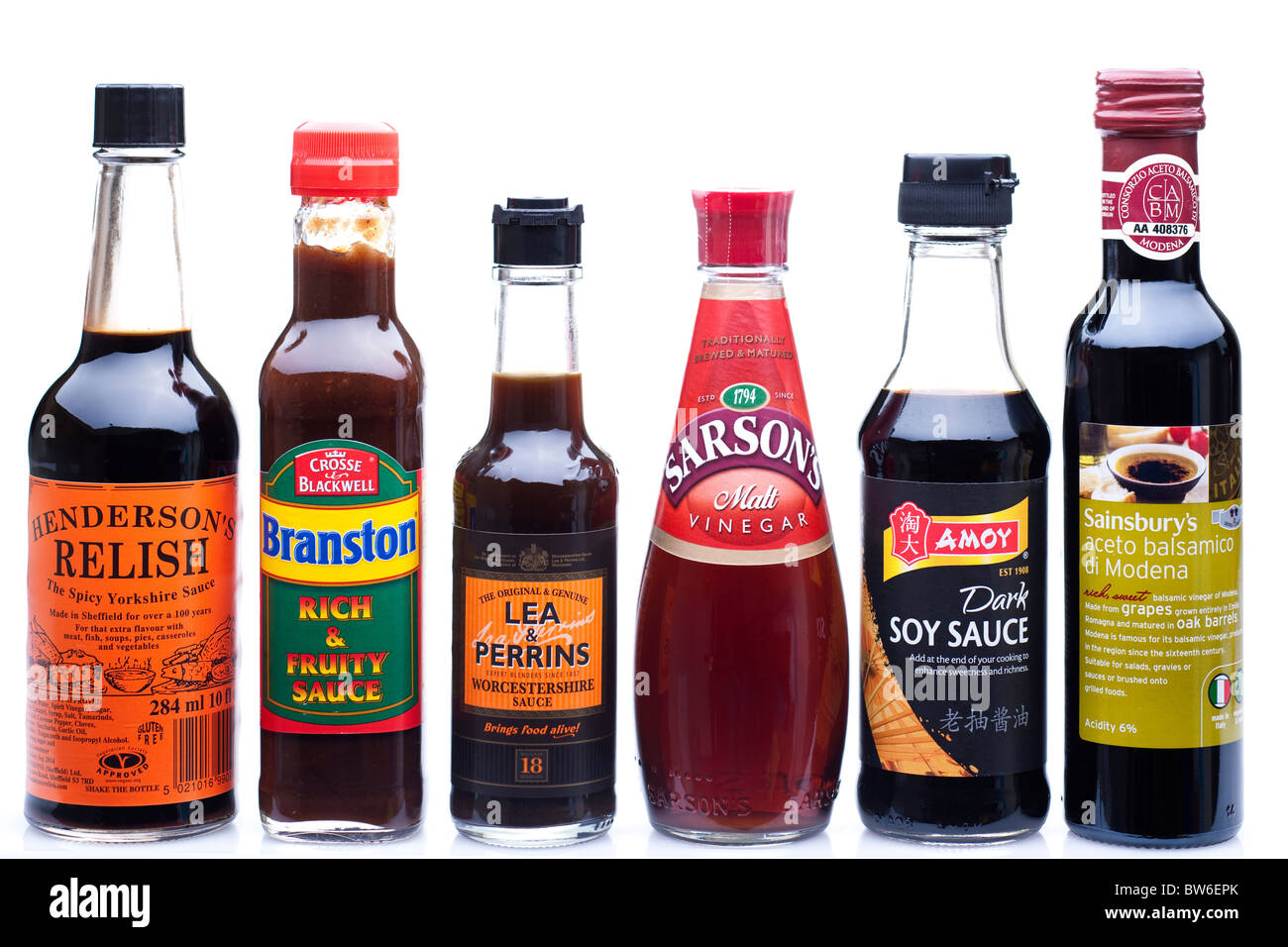 Mixed bottles of sauces and acid vinegars Stock Photo