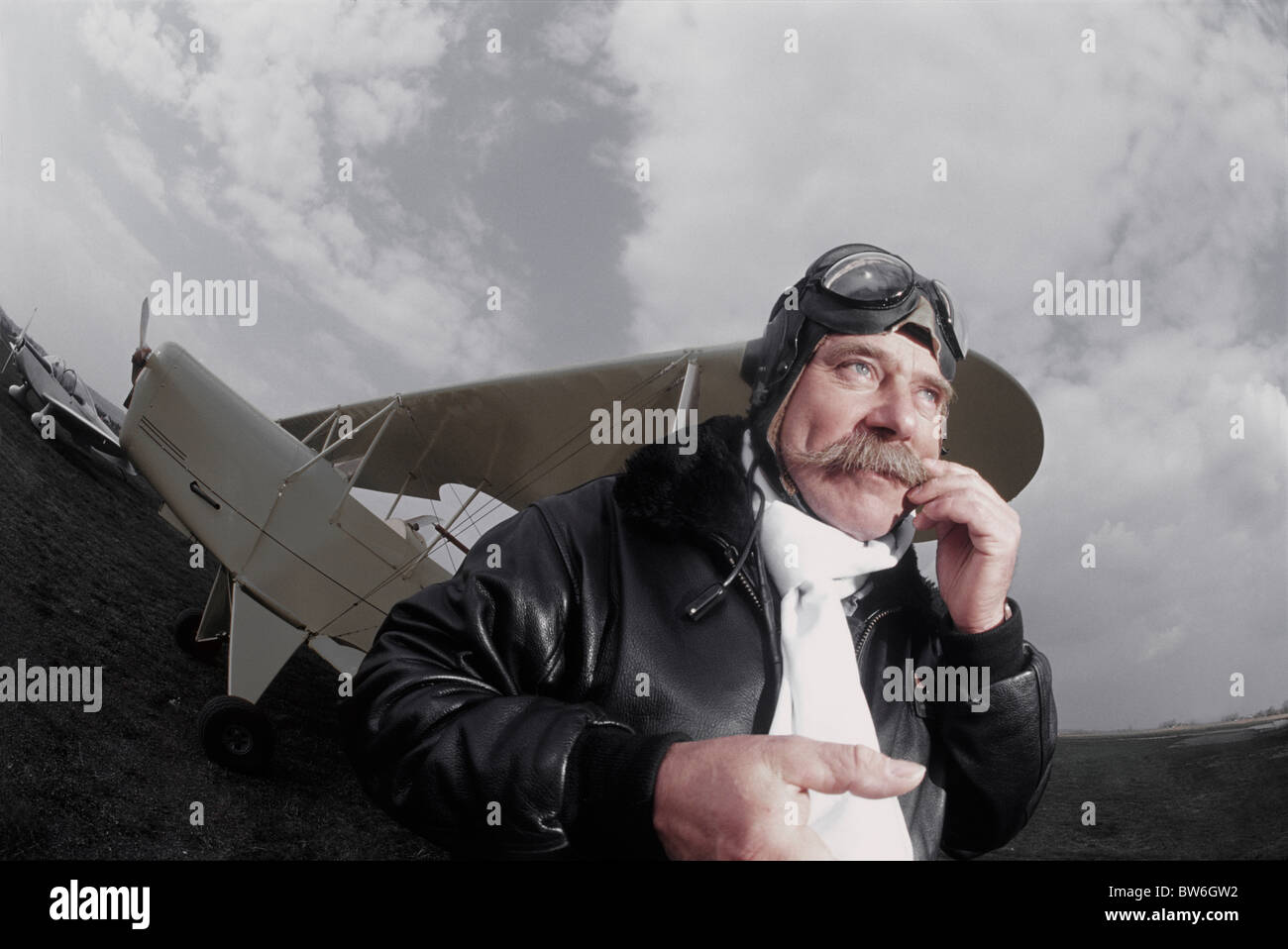 French pilot scratching his mustaches front of his biplane Stock Photo