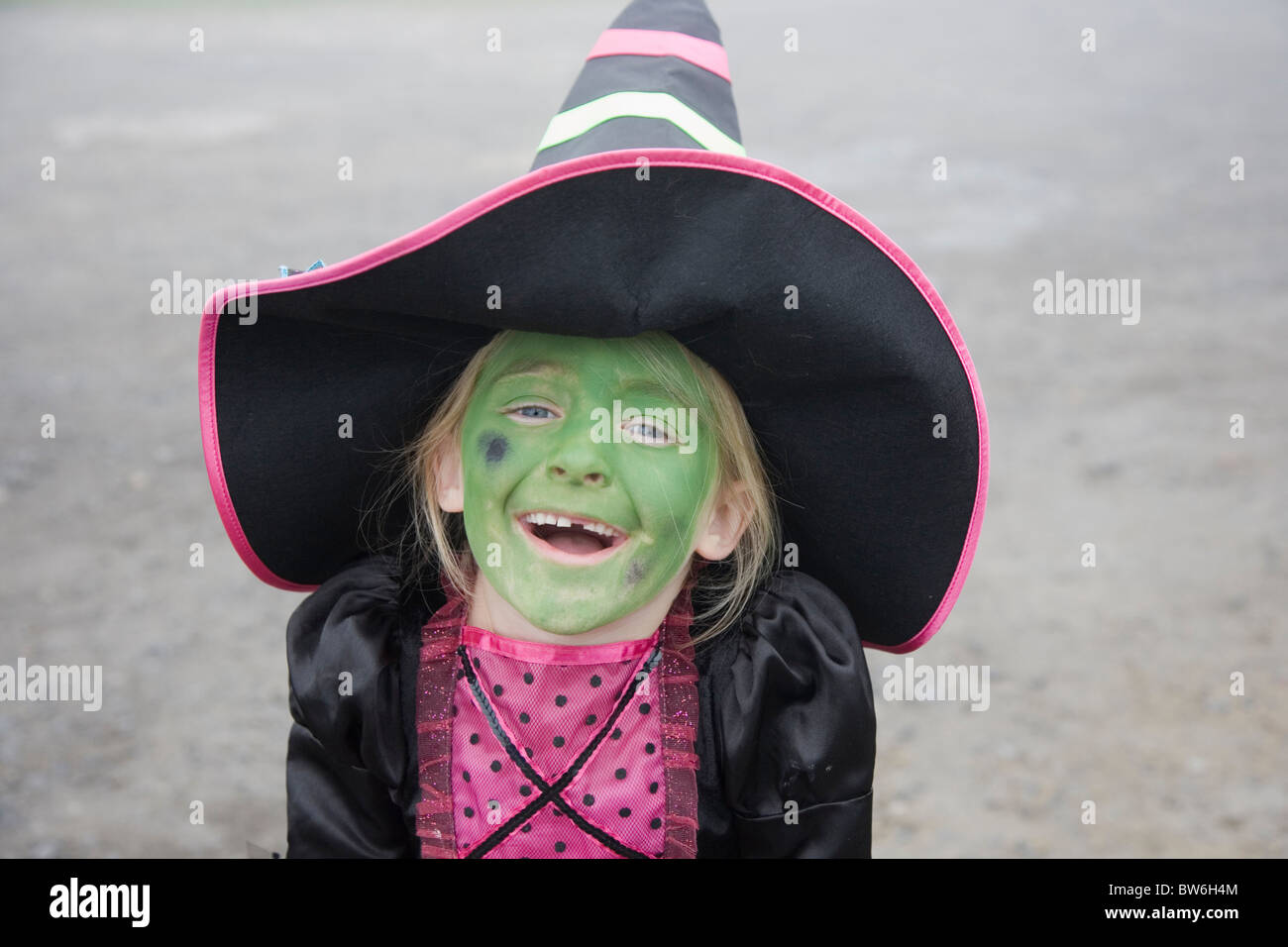 Young child (girl) wearing Halloween Witches Costume and face paint Stock Photo