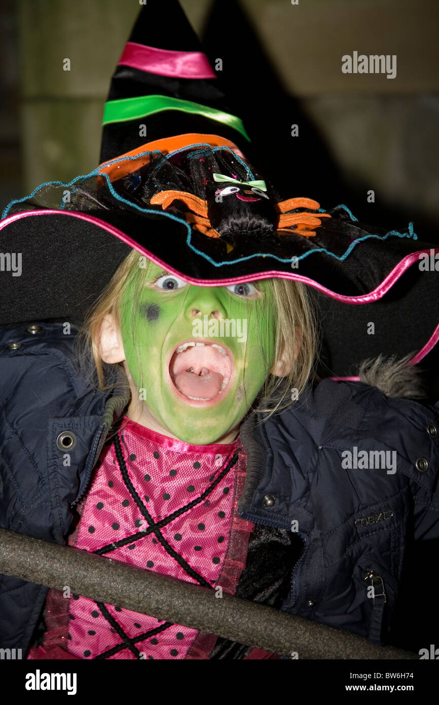 Young child (girl) wearing Halloween Witches Costume and face paint Stock Photo