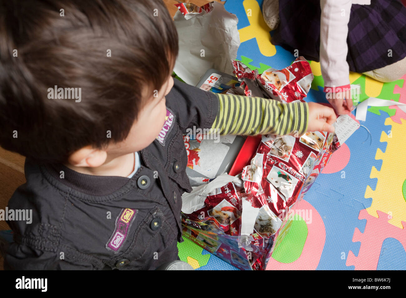 Kids opening presents  on Christmas day Stock Photo