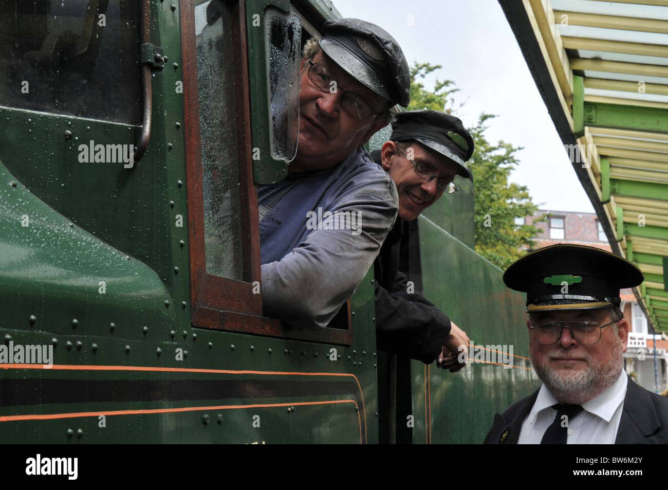 Swanage Station Steam train with driver guard stoker Stock Photo Alamy