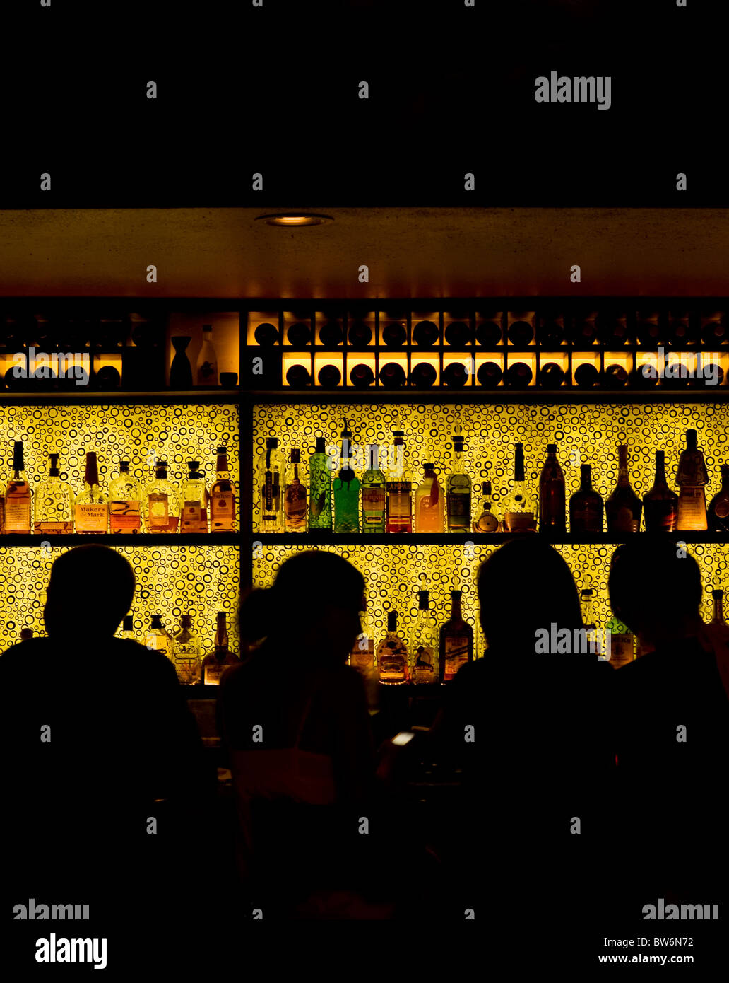 Silhouette of patrons at a back lit bar. Stock Photo