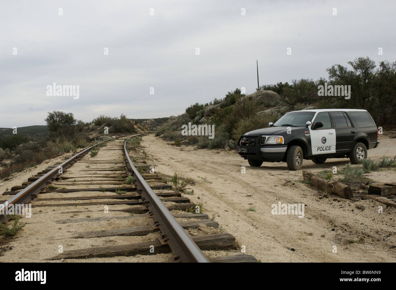 A railroad police officer patrols a remote stretch of track Stock Photo