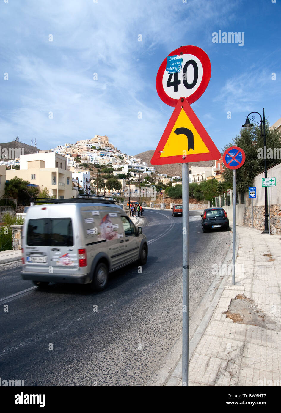 Traffic signs on the road leading to Ano Syros from Ermoupolis, on the Greek Cyclade island of Syros. Stock Photo