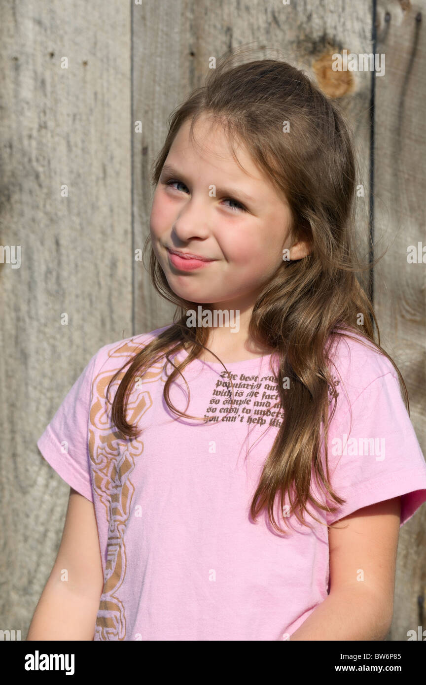 Young girl showing happy confidence looking at the camera and smiling, eight years old, casual dress. Stock Photo