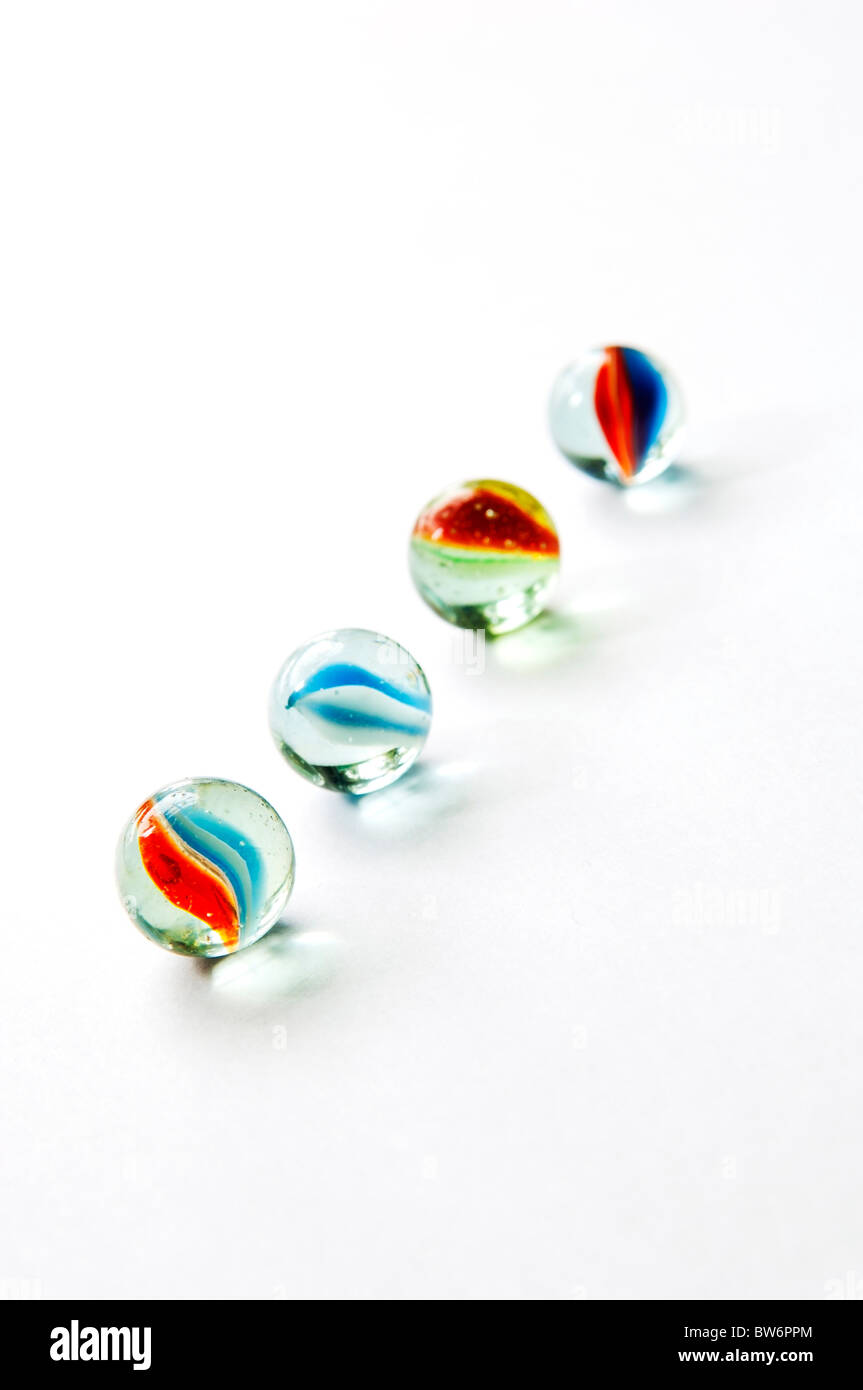 Brightly colored marbles in different shades on bright white Stock