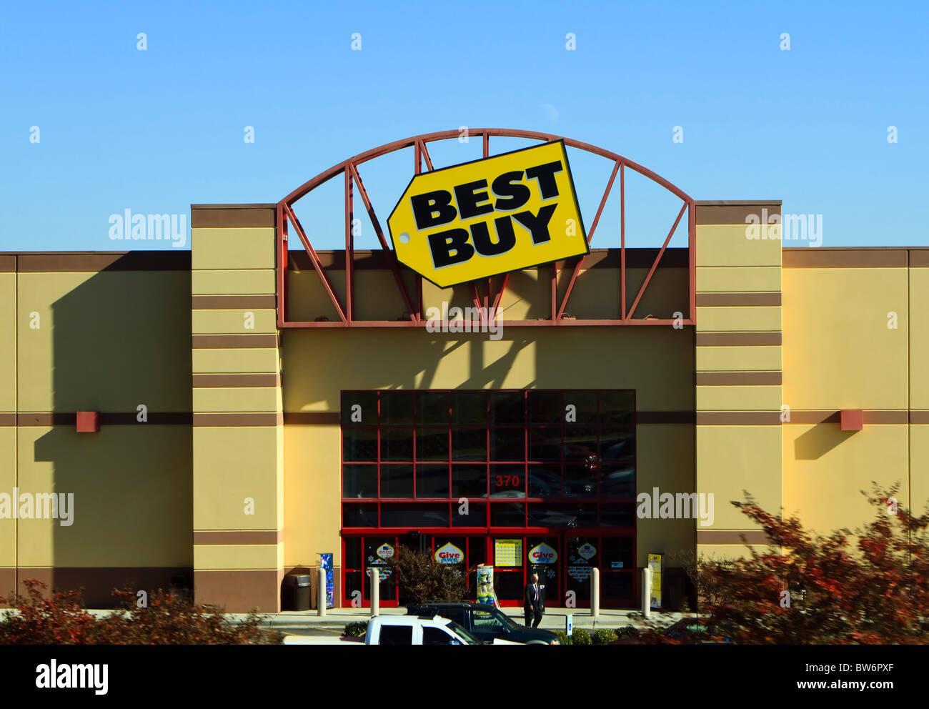 The front entrance and logo sign on a Best Buy retail electronics store on a clear Fall day. Stock Photo