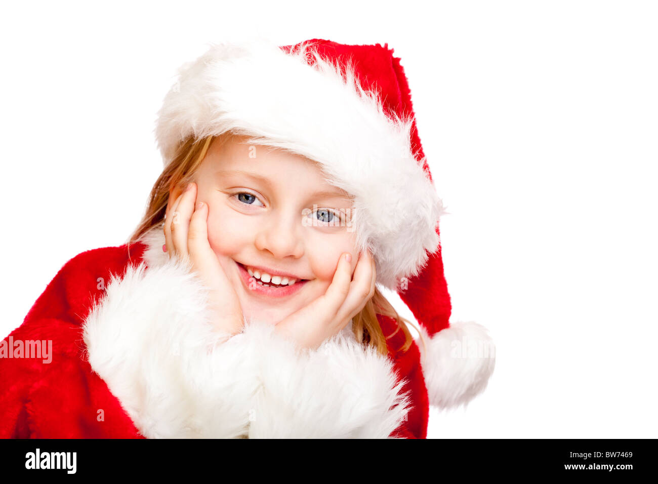 Small girl dressed as Santa Claus smiles happy.  Isolated on white background. Stock Photo