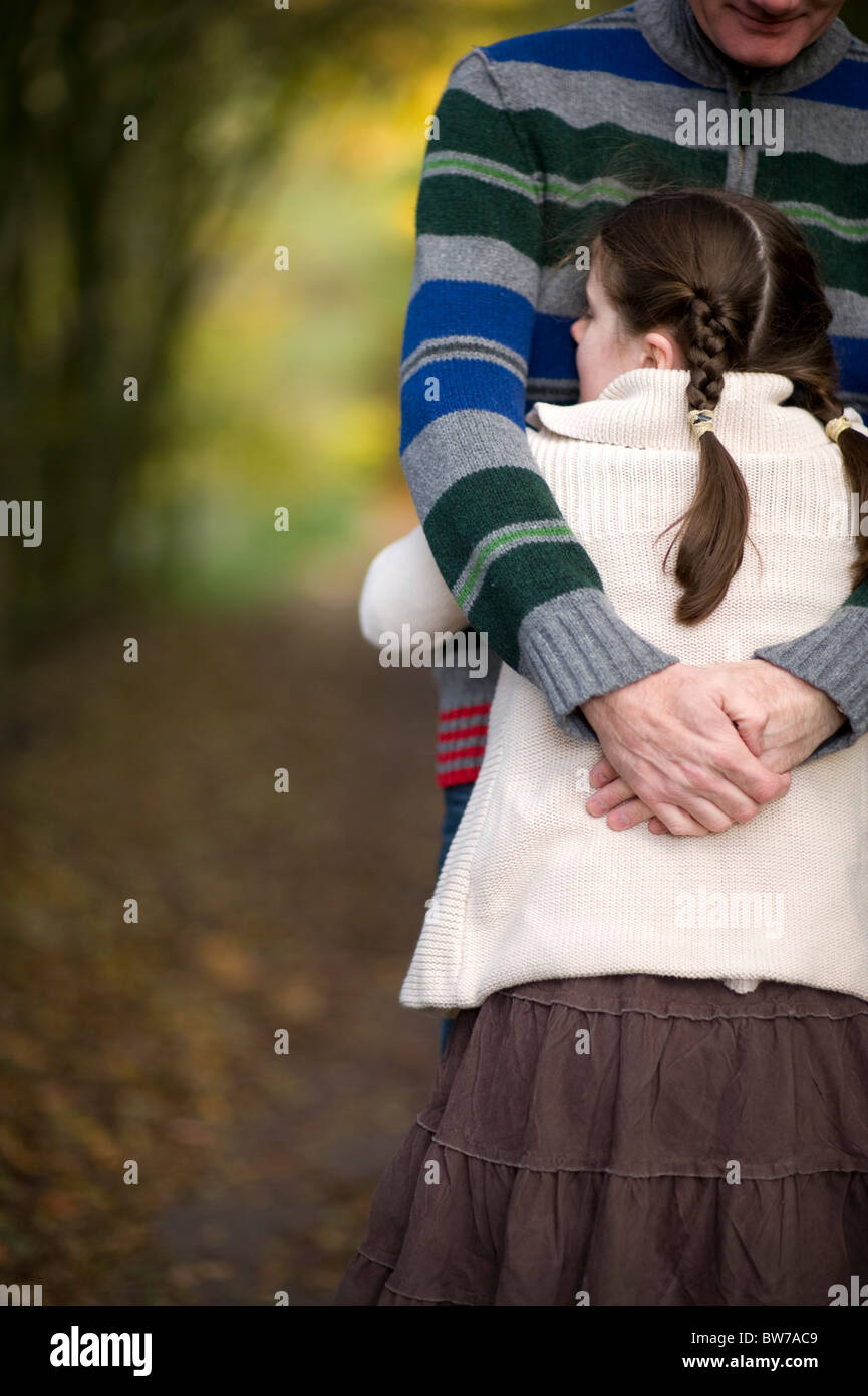 father and daughter hugging outdoors in an autumn woodland Stock Photo ...