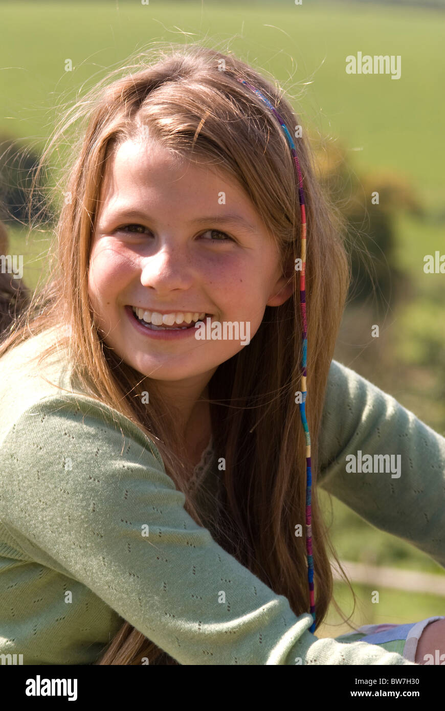 Portrait of a smiling girl with long brown hair Stock Photo - Alamy
