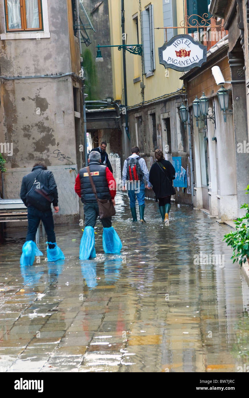 Improvised waterproof footwear during an acqua alta in Venice, Italy Stock Photo