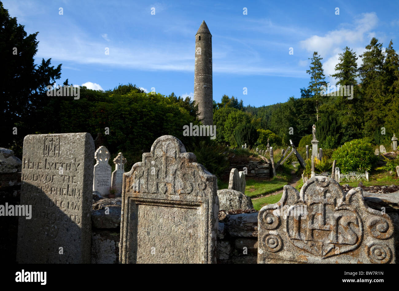 Round Tower and Graveyard in Glendalough Early Monastic Site, County Wicklow, Ireland Stock Photo
