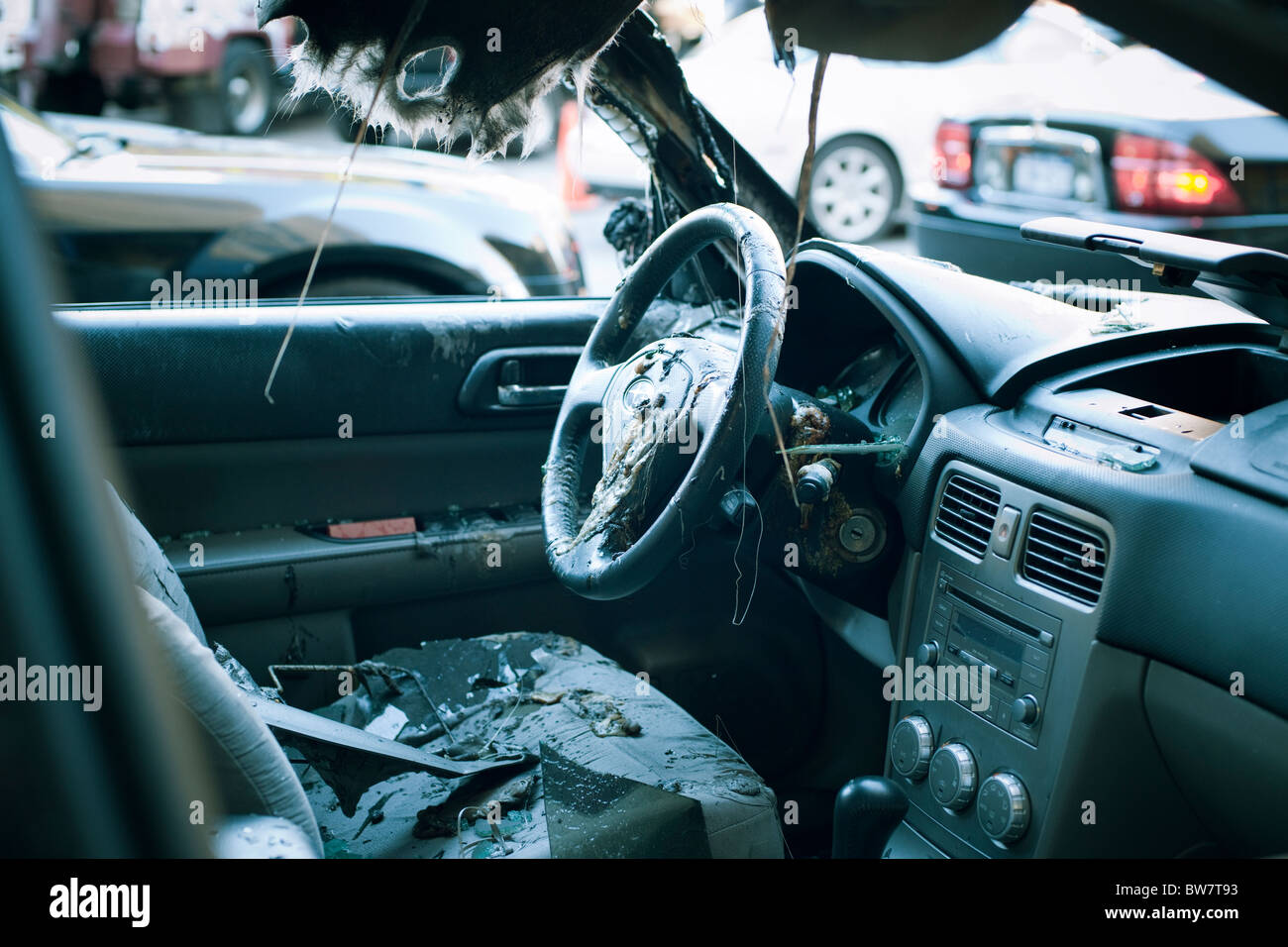 Accident damaged automobile parked outside an auto repair shop in New