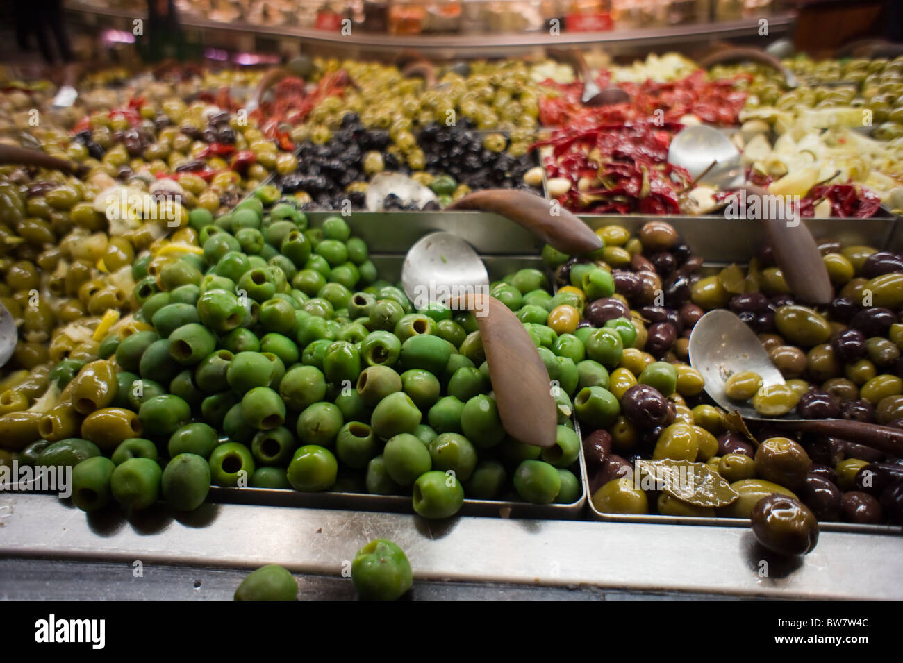 Olives and other pickles in the olive bar in the Whole Foods supermarket in the Tribeca neighborhood of New York Stock Photo