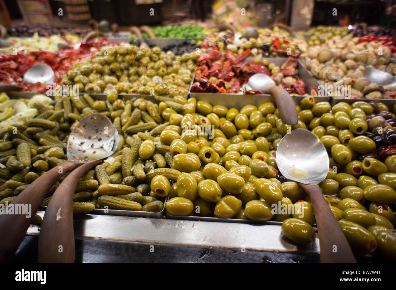 Olives and other pickles in the olive bar in the Whole Foods supermarket in the Tribeca neighborhood of New York Stock Photo
