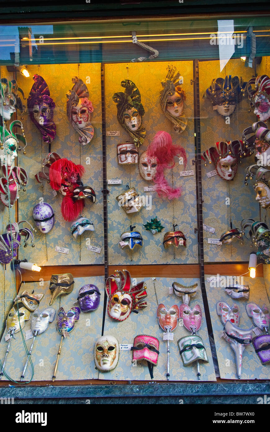 Colourful festival masks in a shop window, Venice Stock Photo