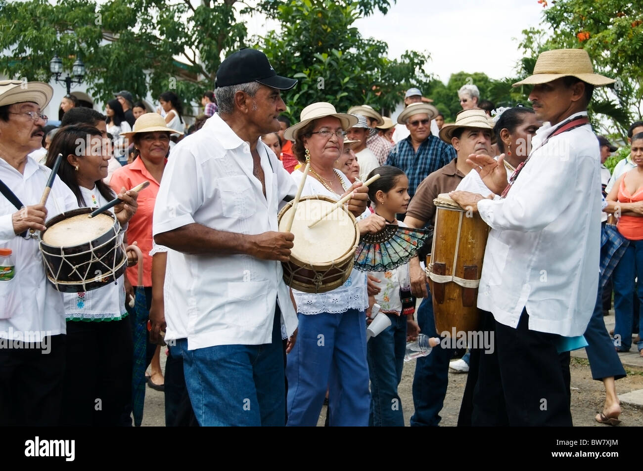 A group of musicians celebrating the Carriage Festival in Pedasi Panama plays during a parade in the street around the plaza. Stock Photo