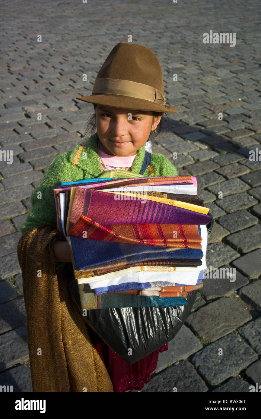 Young indigenous girl selling shawls, Quito, Ecuador Stock Photo