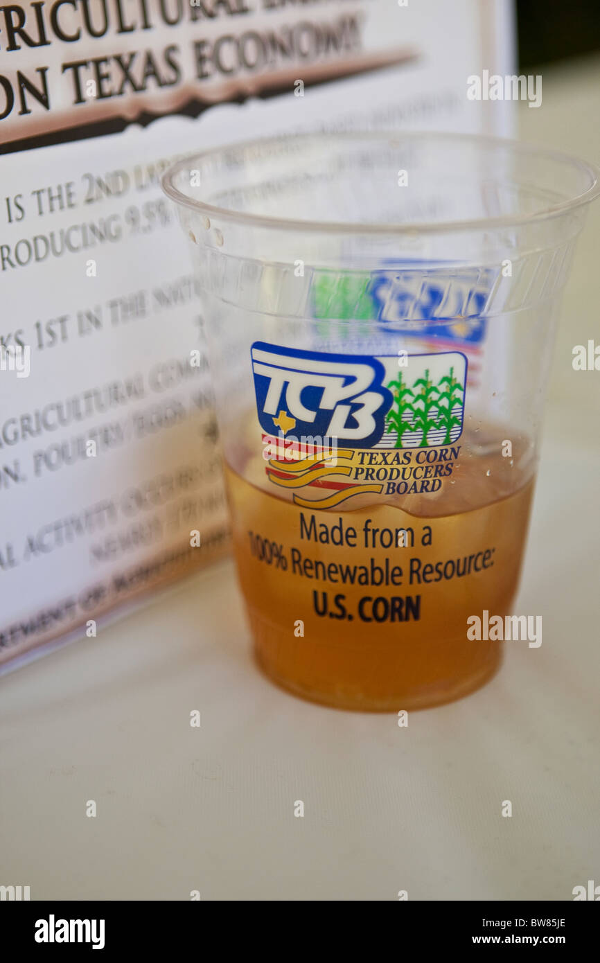 Biodegradable corn plastic cup made of polylactide (PLA) filled with iced tea on tabletop Stock