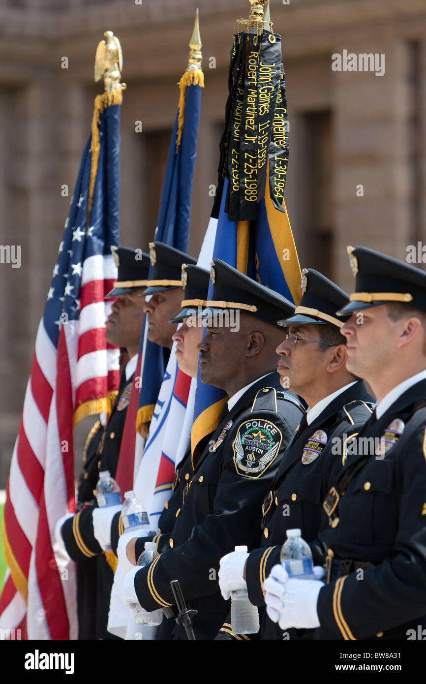 Multi-ethnic group of police officers present flags as color guard during Peace Officers Memorial Day ceremony in Austin, Texas Stock Photo