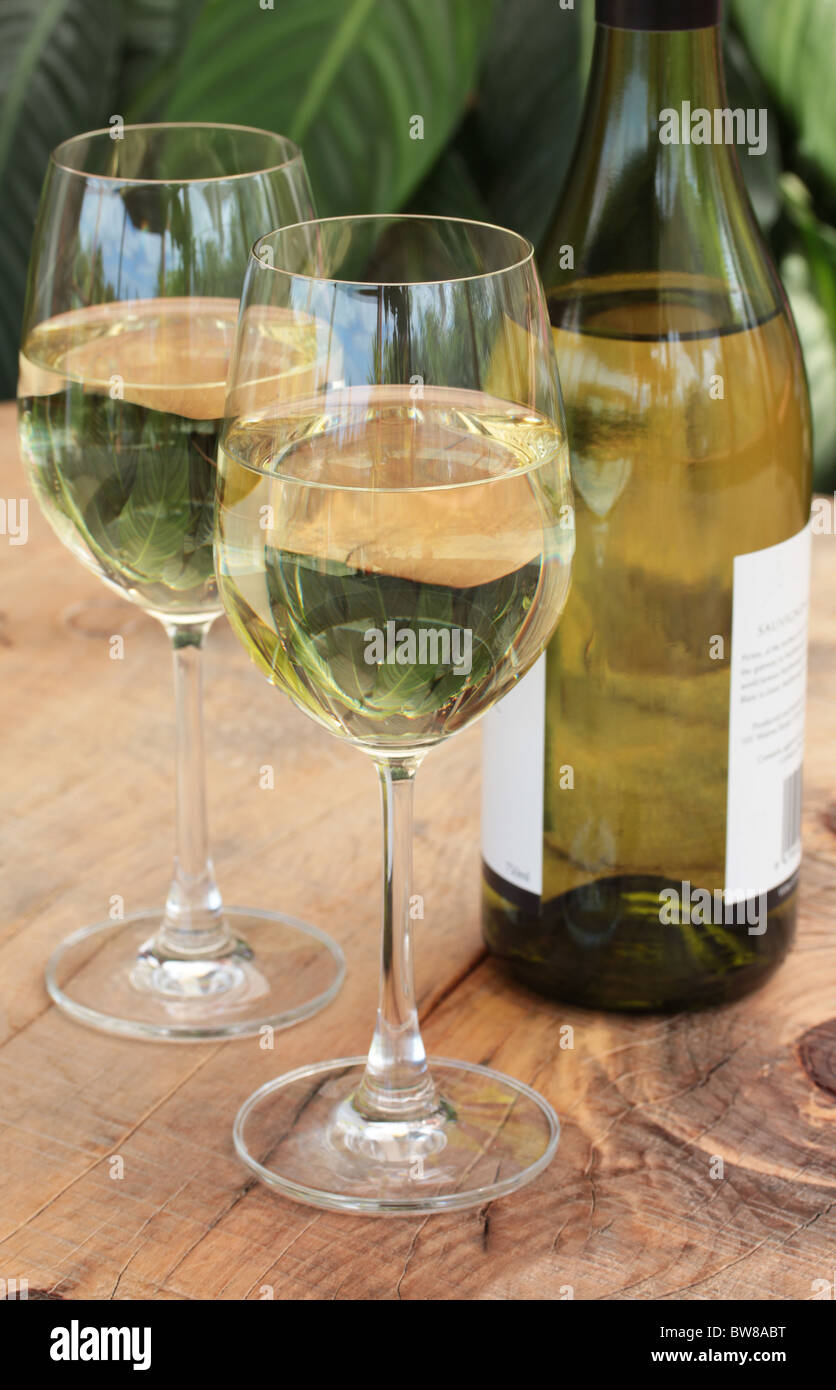 Glasses & Bottle of White Wine on Table Stock Photo