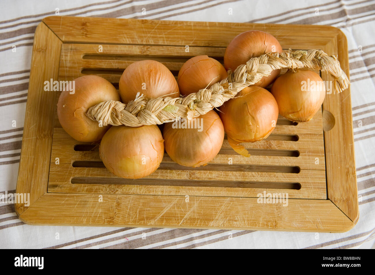 Cord with onions in rural still life Stock Photo