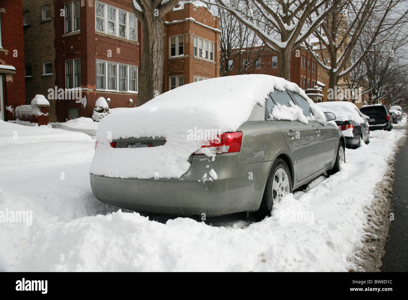 snow covers parked cars on city street Stock Photo - Alamy
