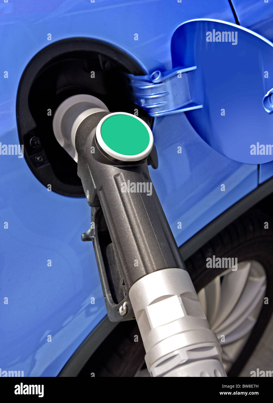 At the gas station pump putting gas into the car Stock Photo Alamy