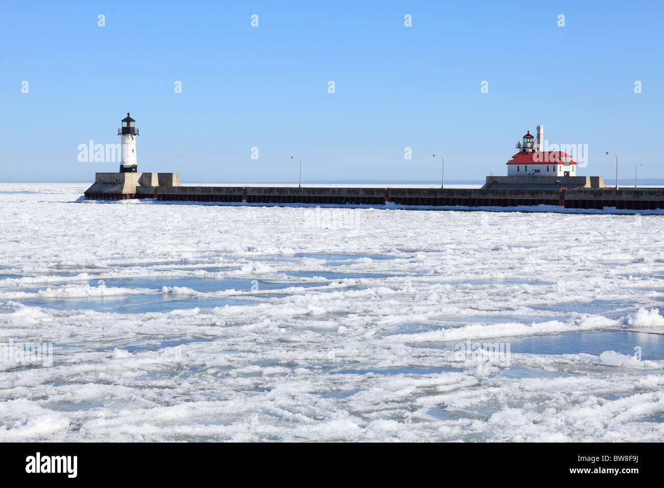 The North Pier Lighthouse (l) and South Breakwater Lighthouse (r) in Duluth, Minnesota on a winter day. Stock Photo