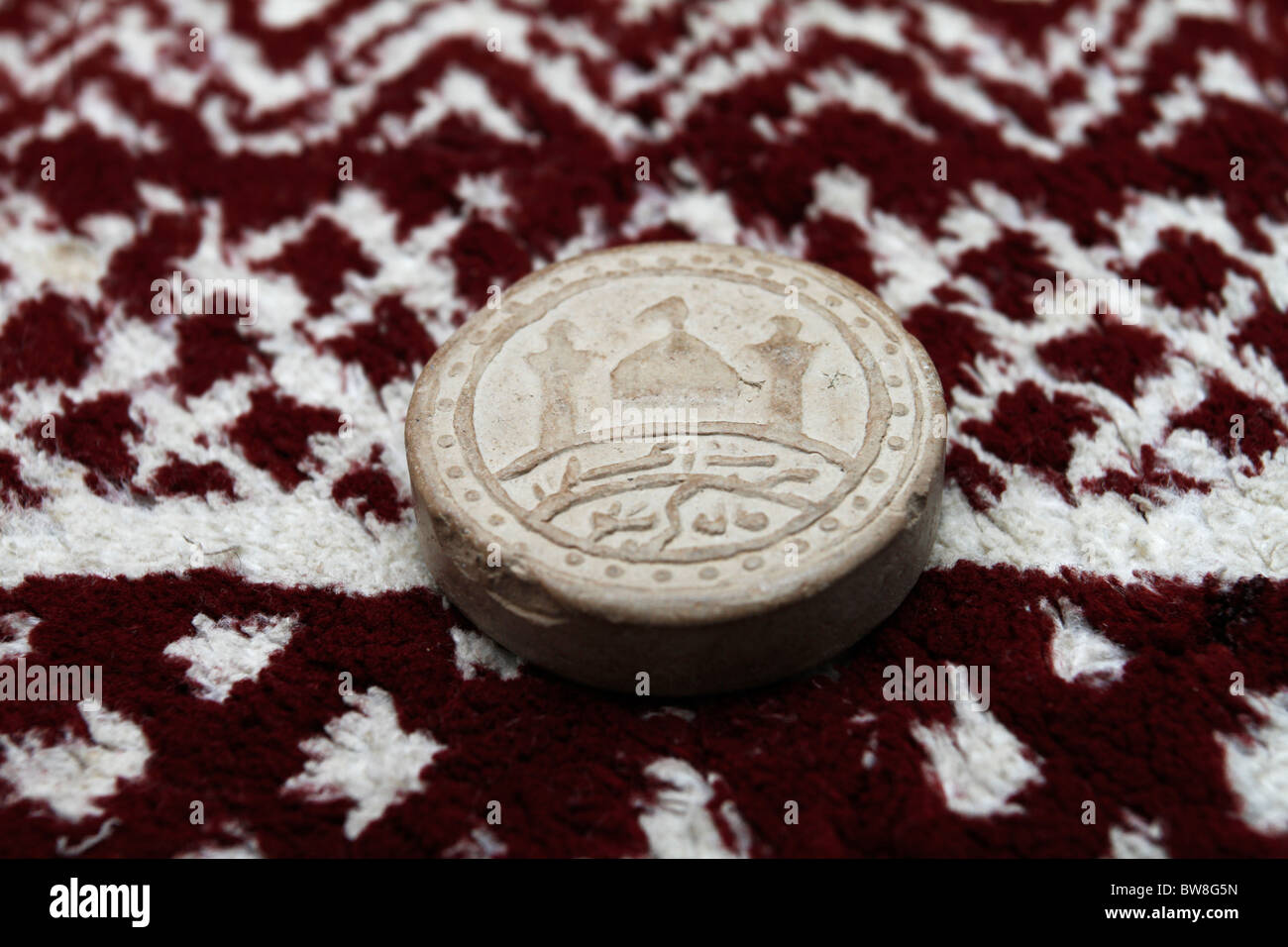 Turba - prayer stone used by Shiite Muslims. Stock Photo