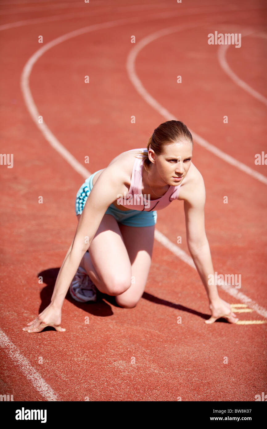 Image of young female ready to start running during marathon Stock Photo